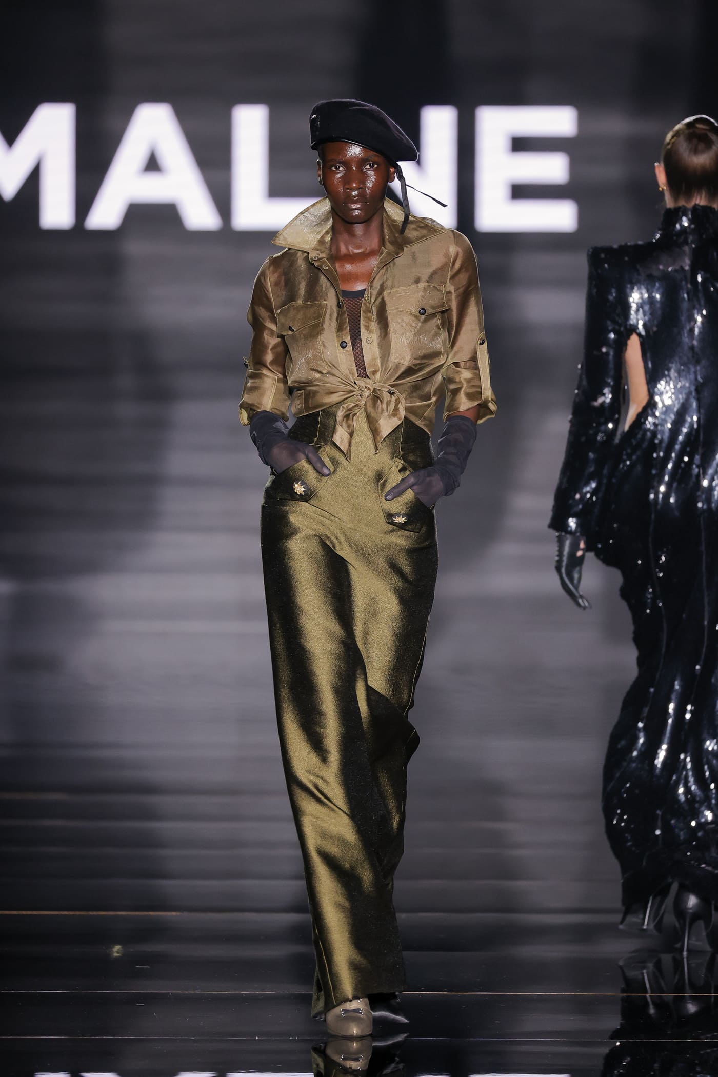 catwalk model in gold two-piece costume