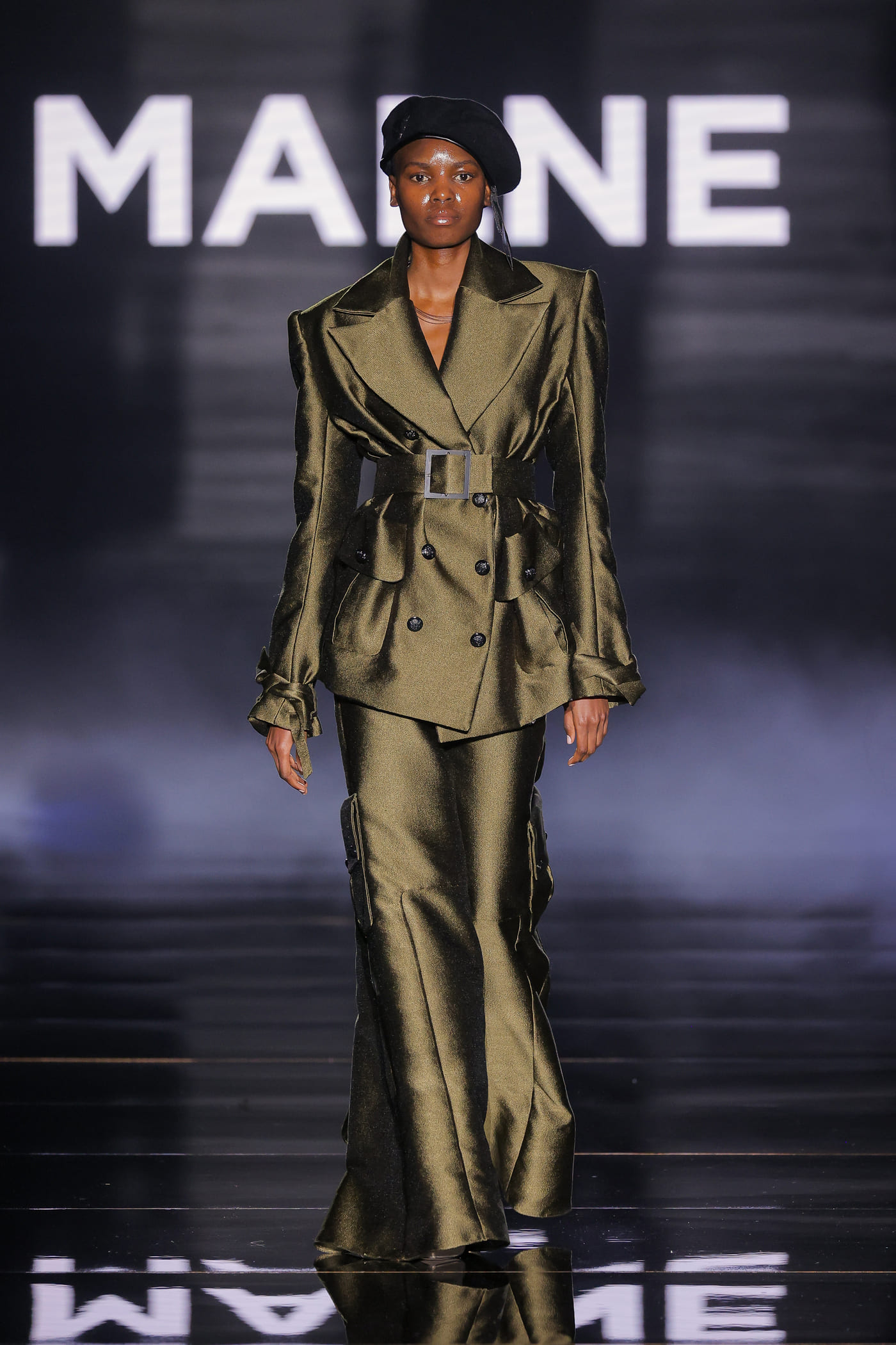 model on the catwalk in military green