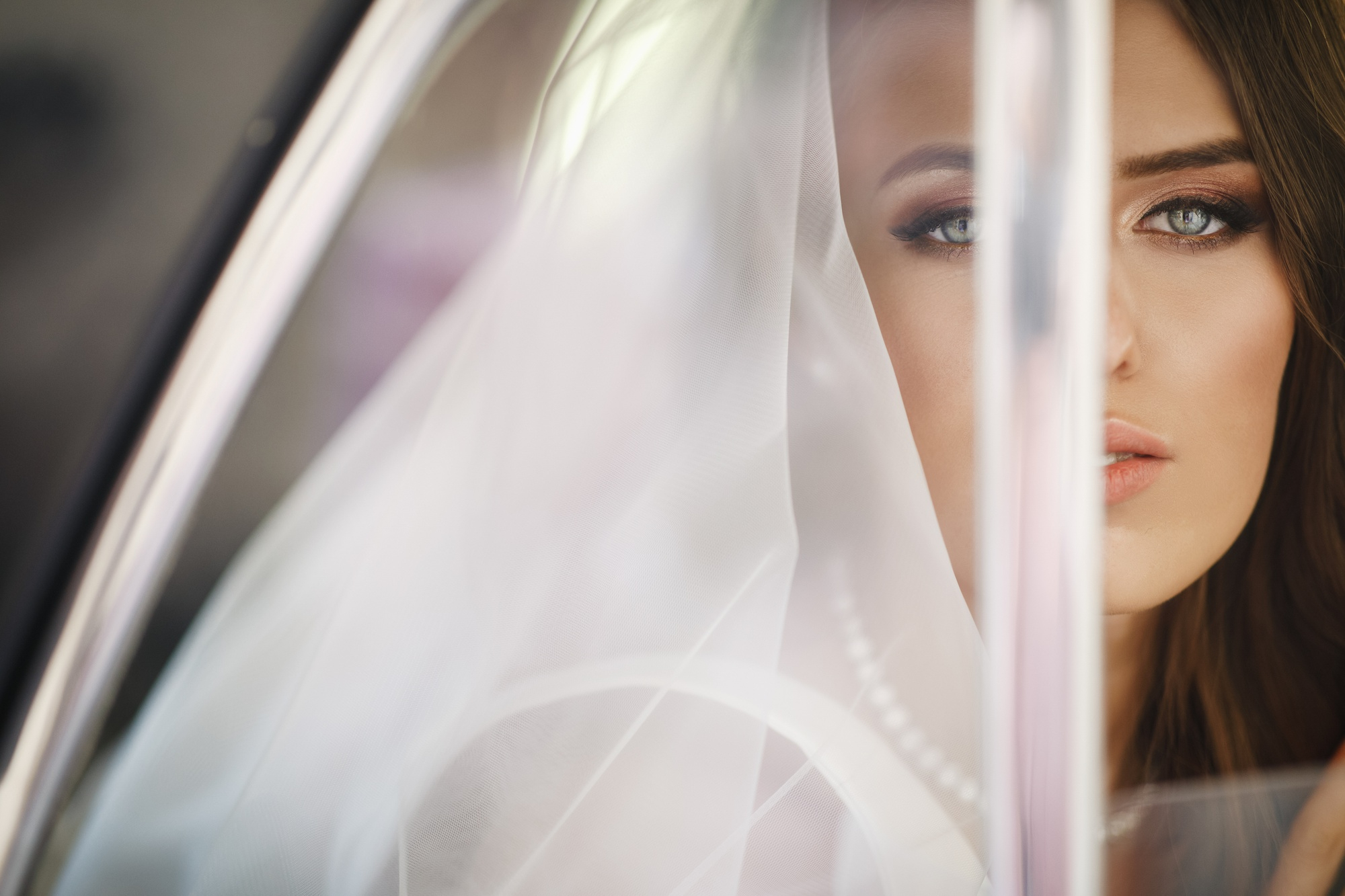 Close up of a 21st century modern wedding dress with handmade lace and elegant details, custom made in a designer atelier.