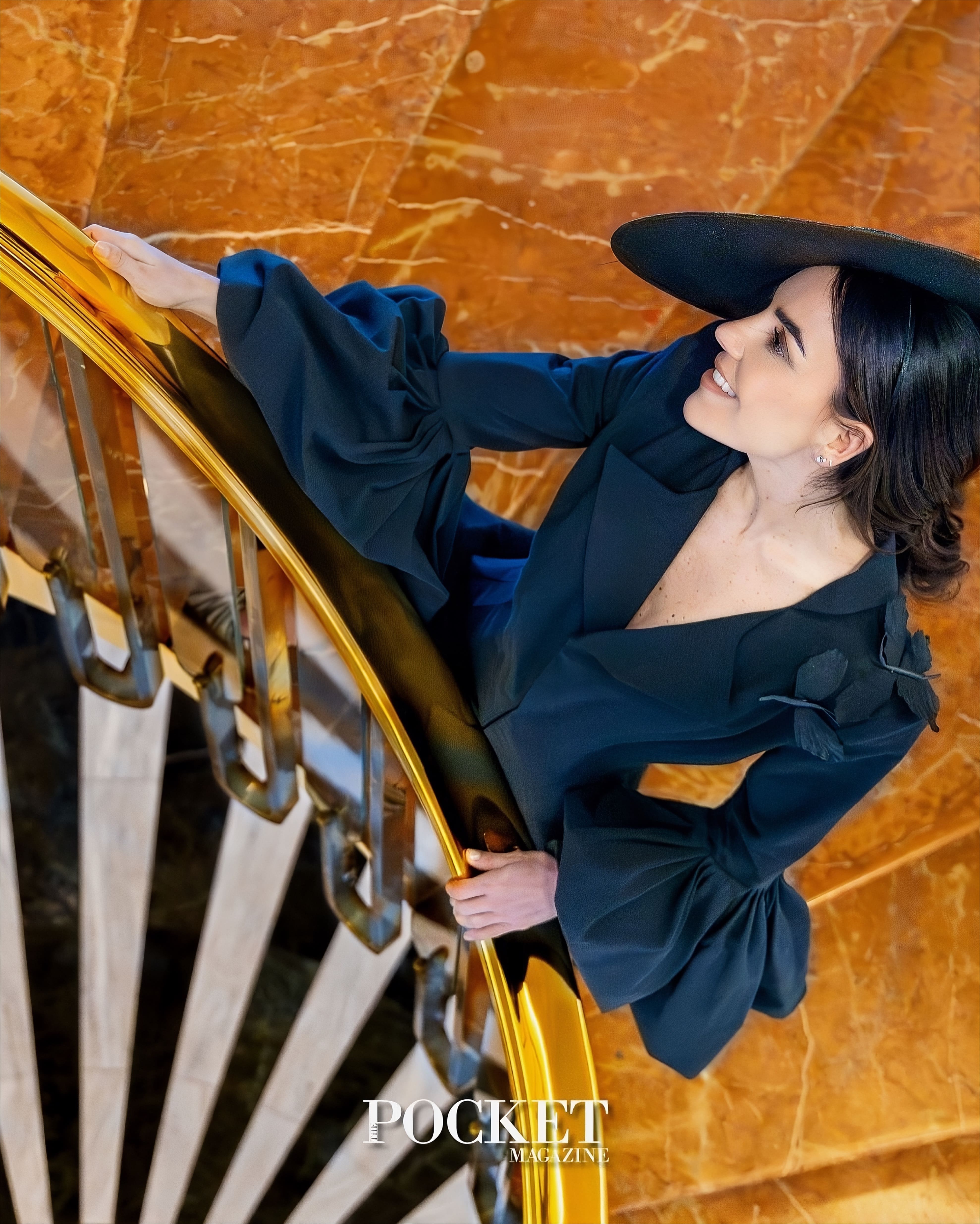 Editorial photograph of an elegant woman in a black hat on a marble staircase, used as the cover of "POCKET MAGAZINE" and associated with MALNE's style.